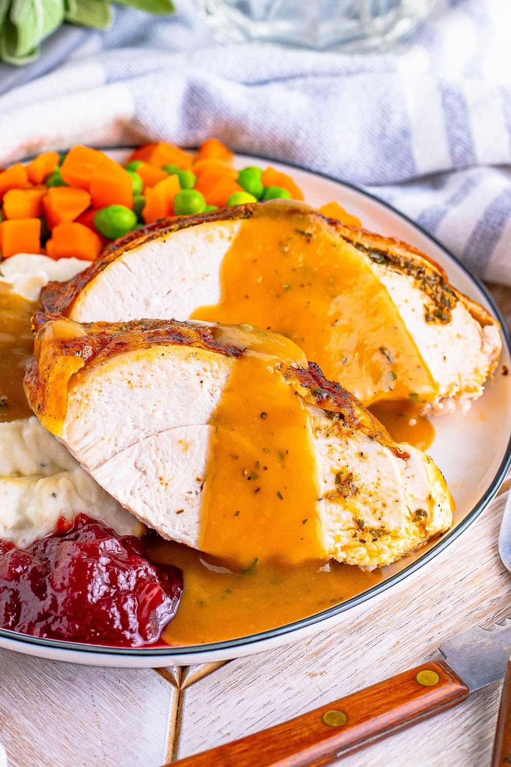 Gravy drizzled over slices of roasted turkey.
