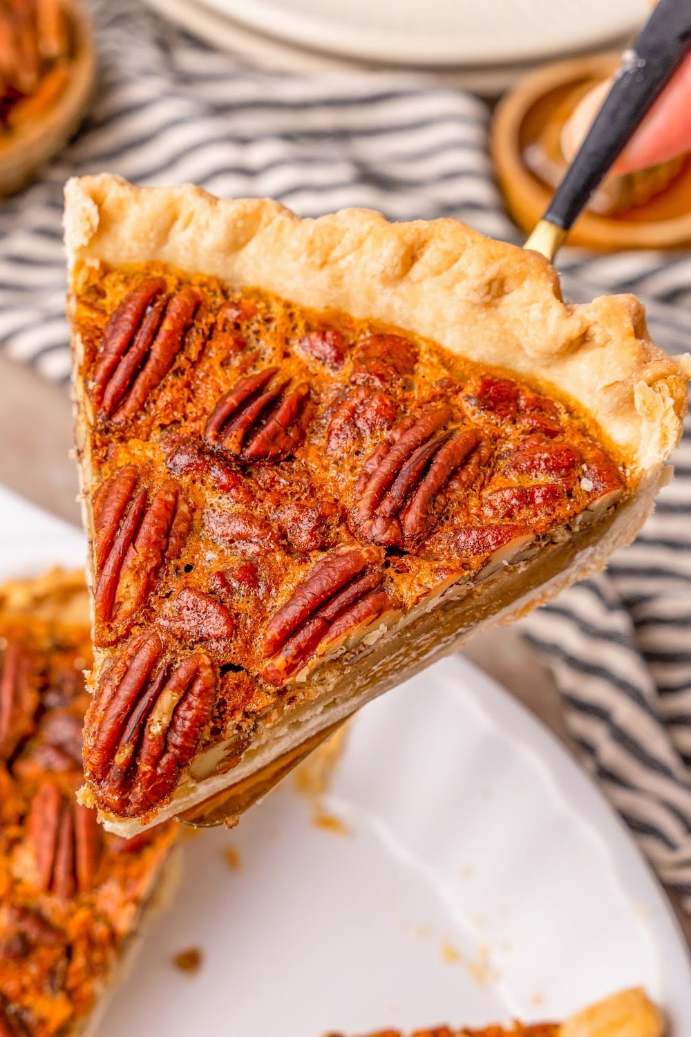 a single slice of pecan pie on a pie spatula.