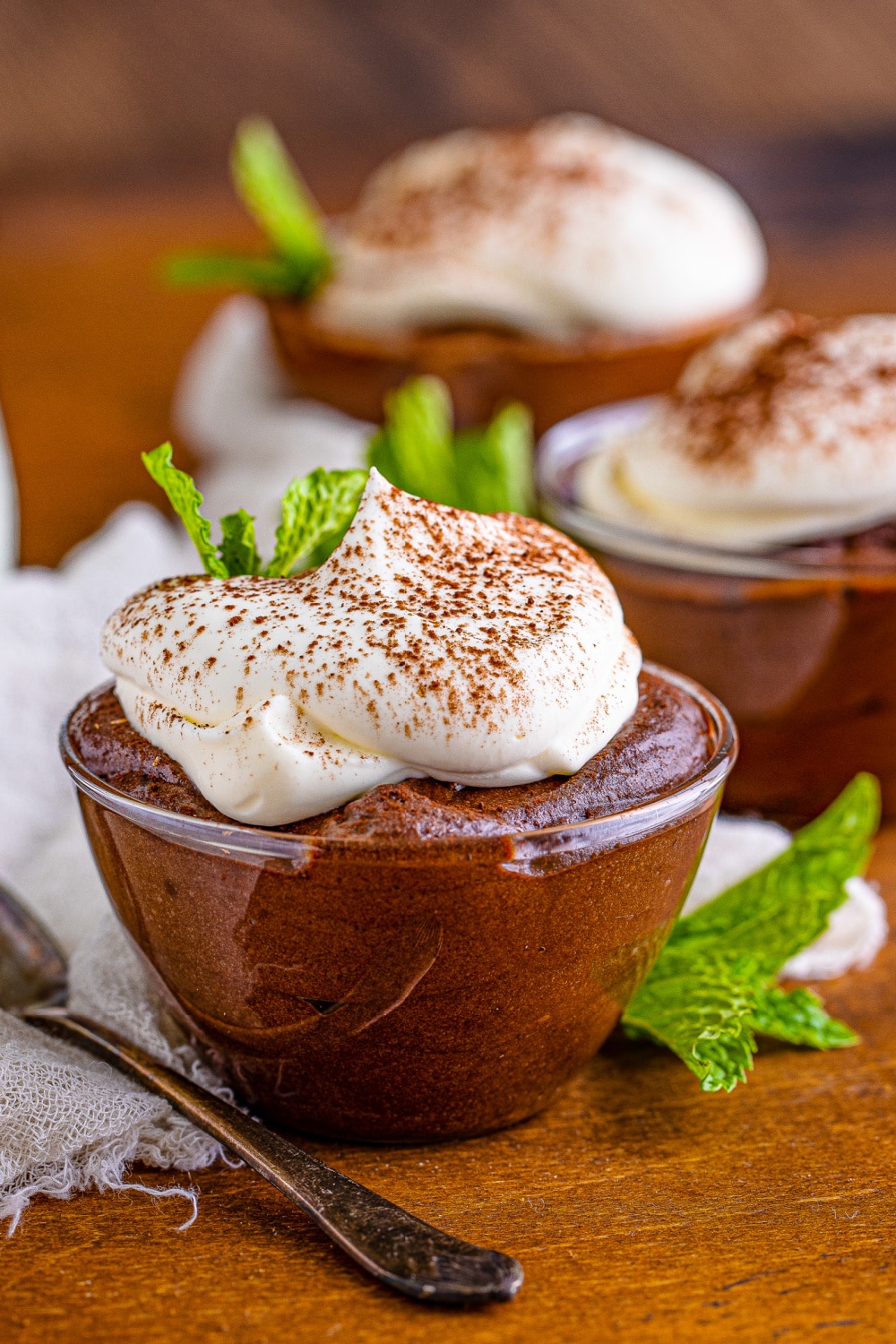 Bowls of Chocolate Mousse topped with whipped cream.