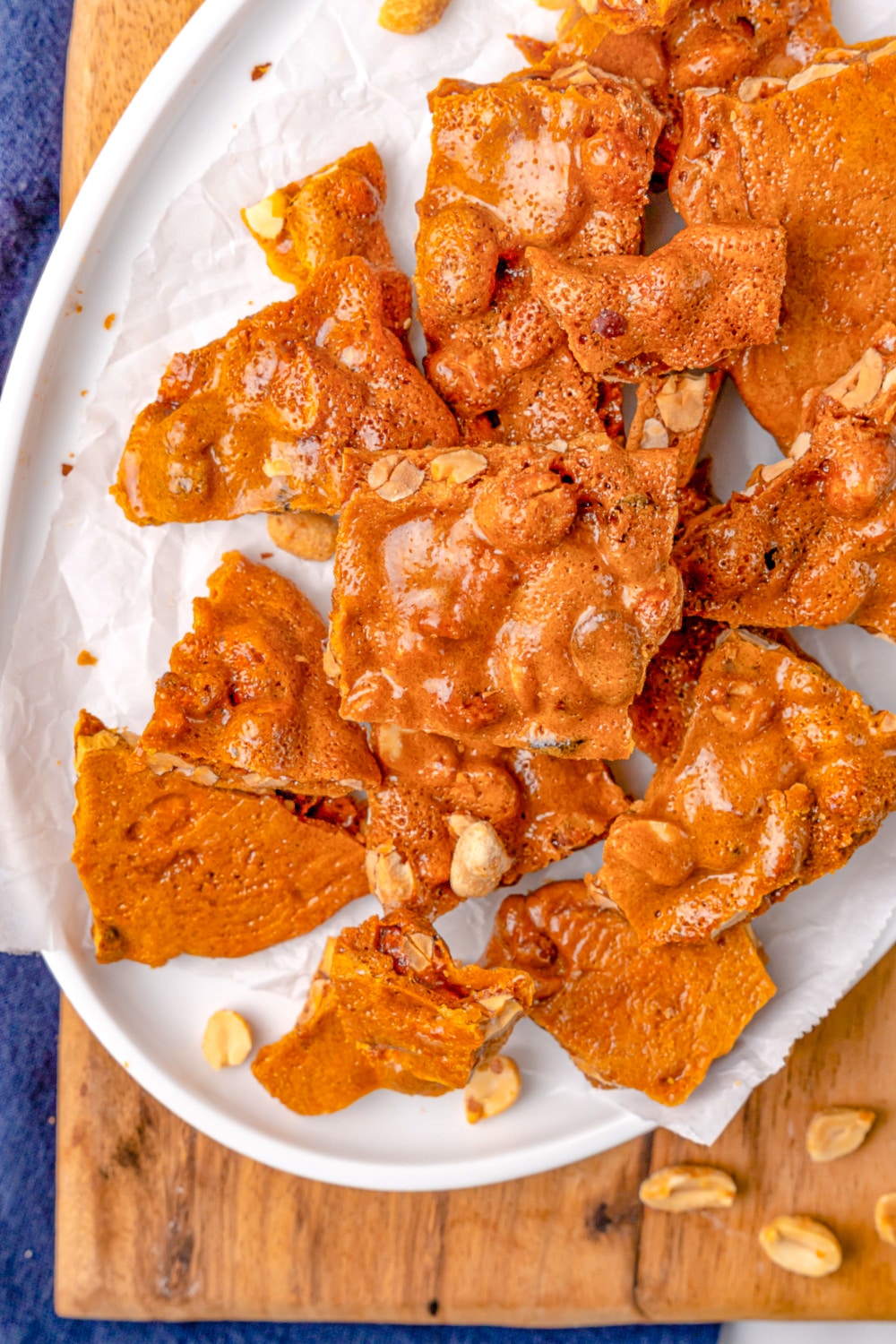 Pieces of Peanut Brittle on white plate.