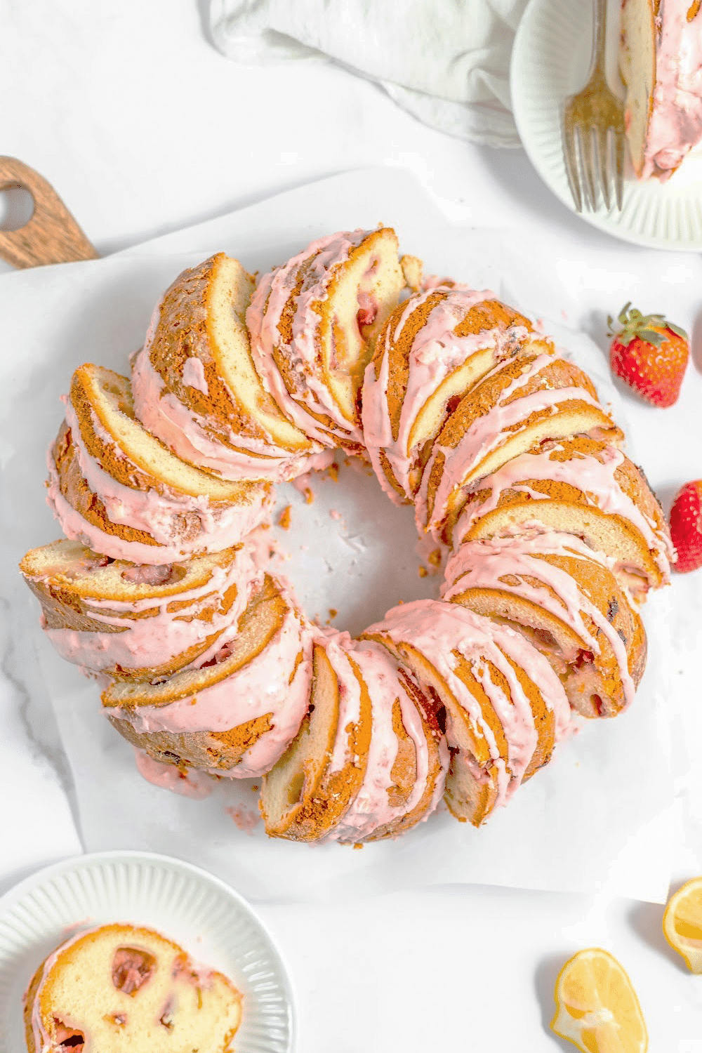 Slices of Strawberry Bundt Cake arranged in a circle on a cake plate.