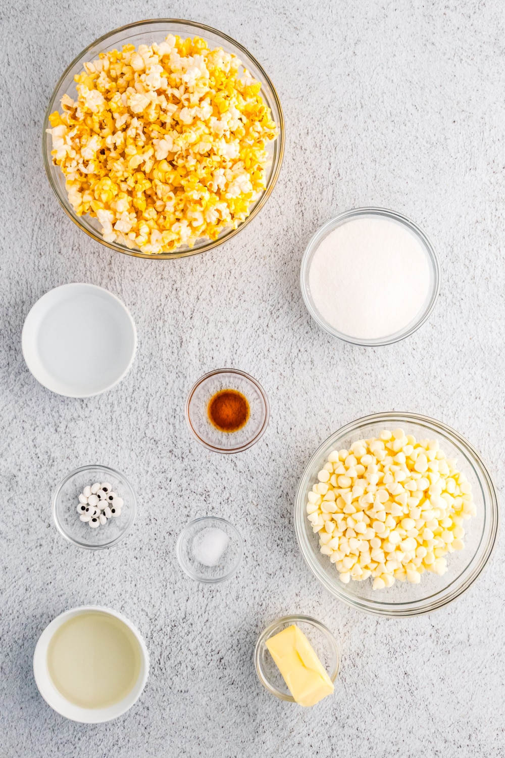 Ingredients needed for this recipe measured and presented in clear glass bowls on a white countertop.