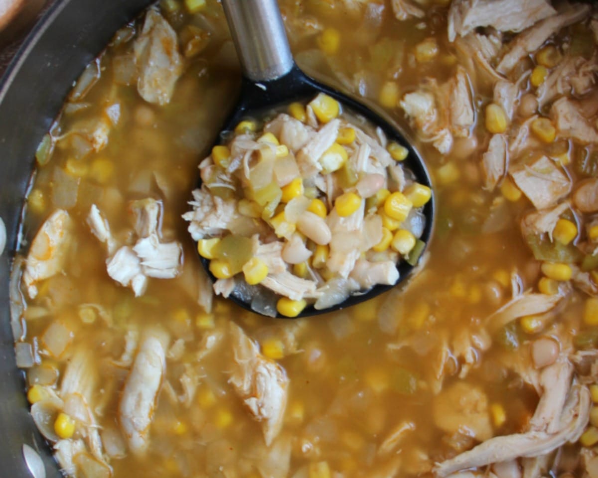 Easy White Chicken Chili in a large pot with a ladle. 