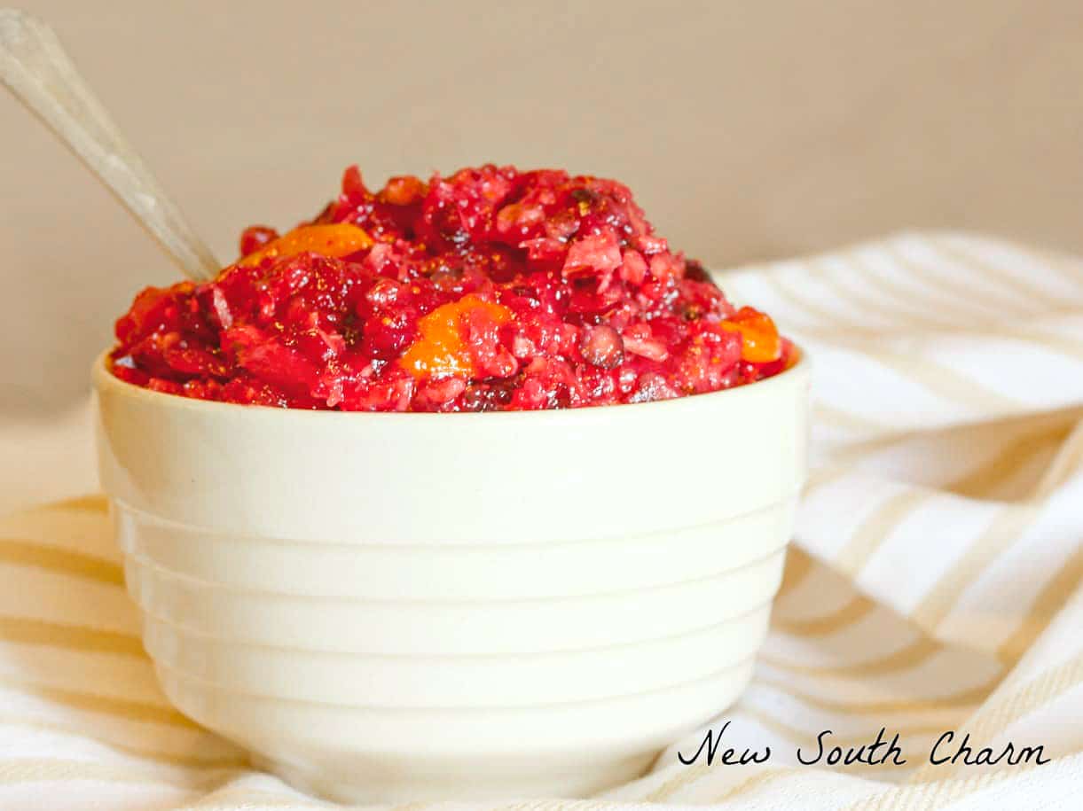 Cranberry relish in a small white bowl with a spoon.