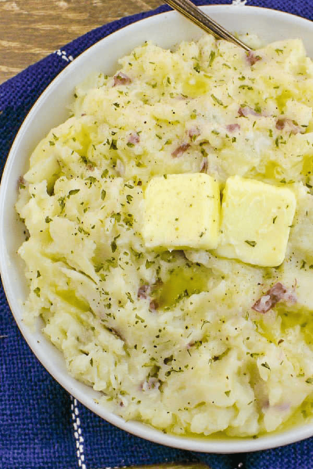 Mashed Potatoes with pats of butter on the top.