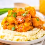 Slow Cooker Hawaiian Chicken with BBQ sauce piled high on a bed of mashed potatoes.