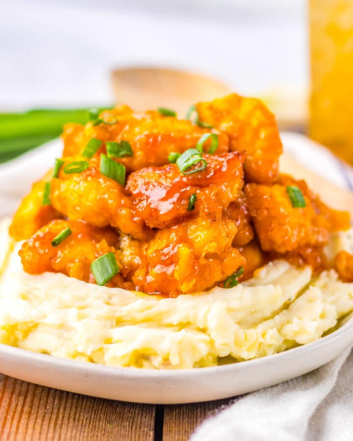 Slow Cooker Hawaiian Chicken with BBQ sauce piled high on a bed of mashed potatoes.