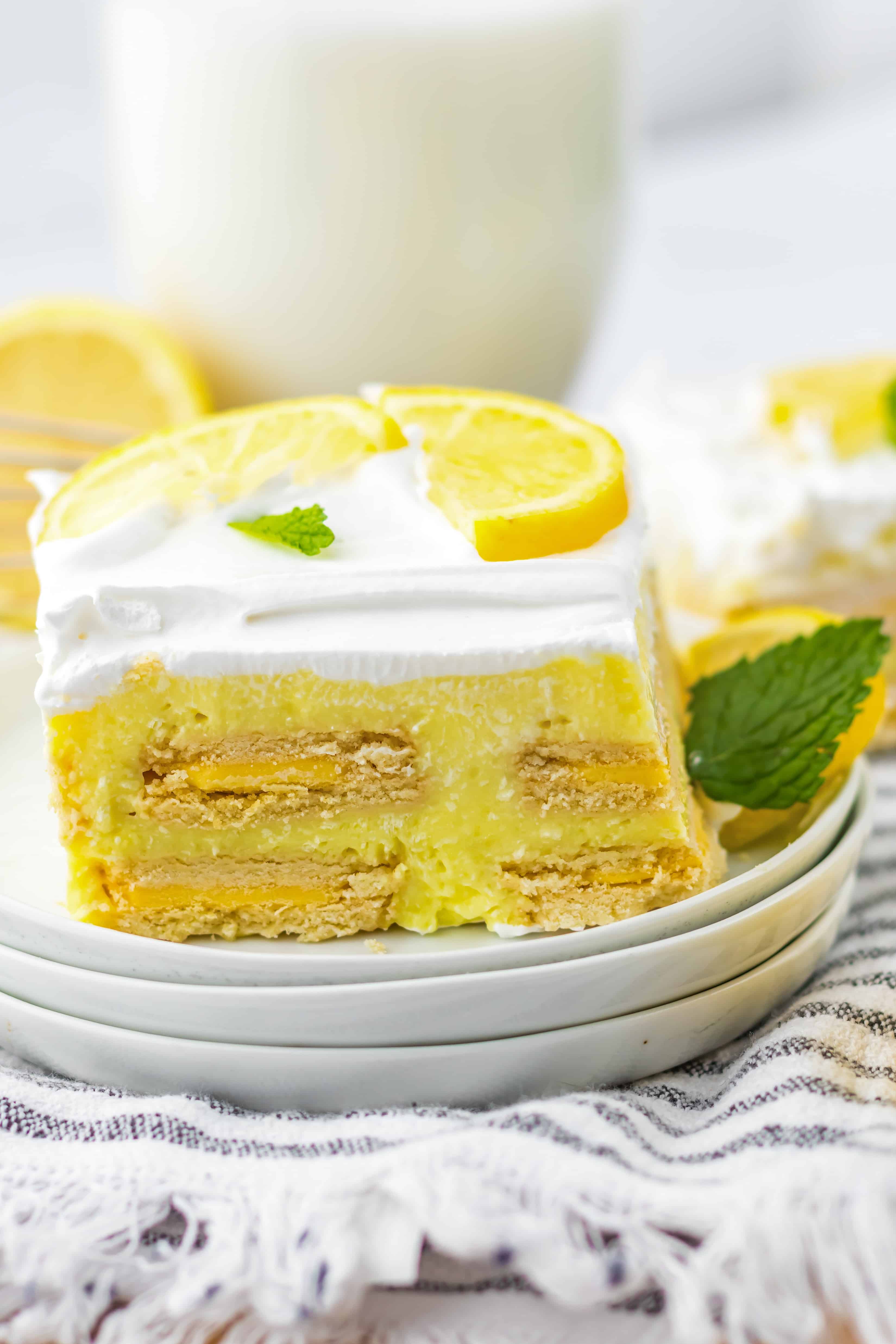A single slice of Lemon Icebox Cake on a white dessert plate. 