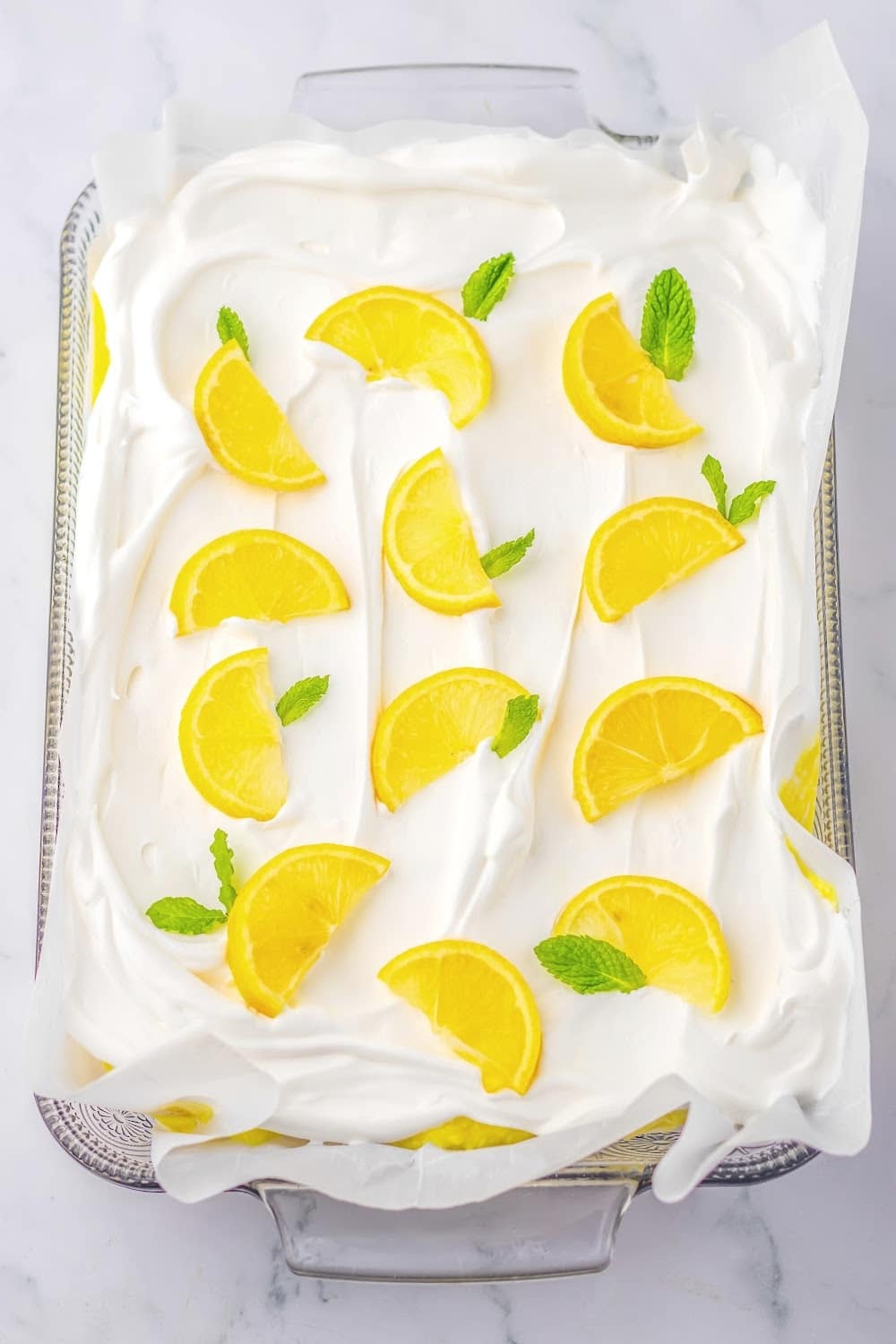 The finished Lemon Icebox Cake topped with fresh lemon slices and mint.