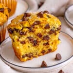 A large chocolates chip muffin cut in half to show the inside of the muffin.