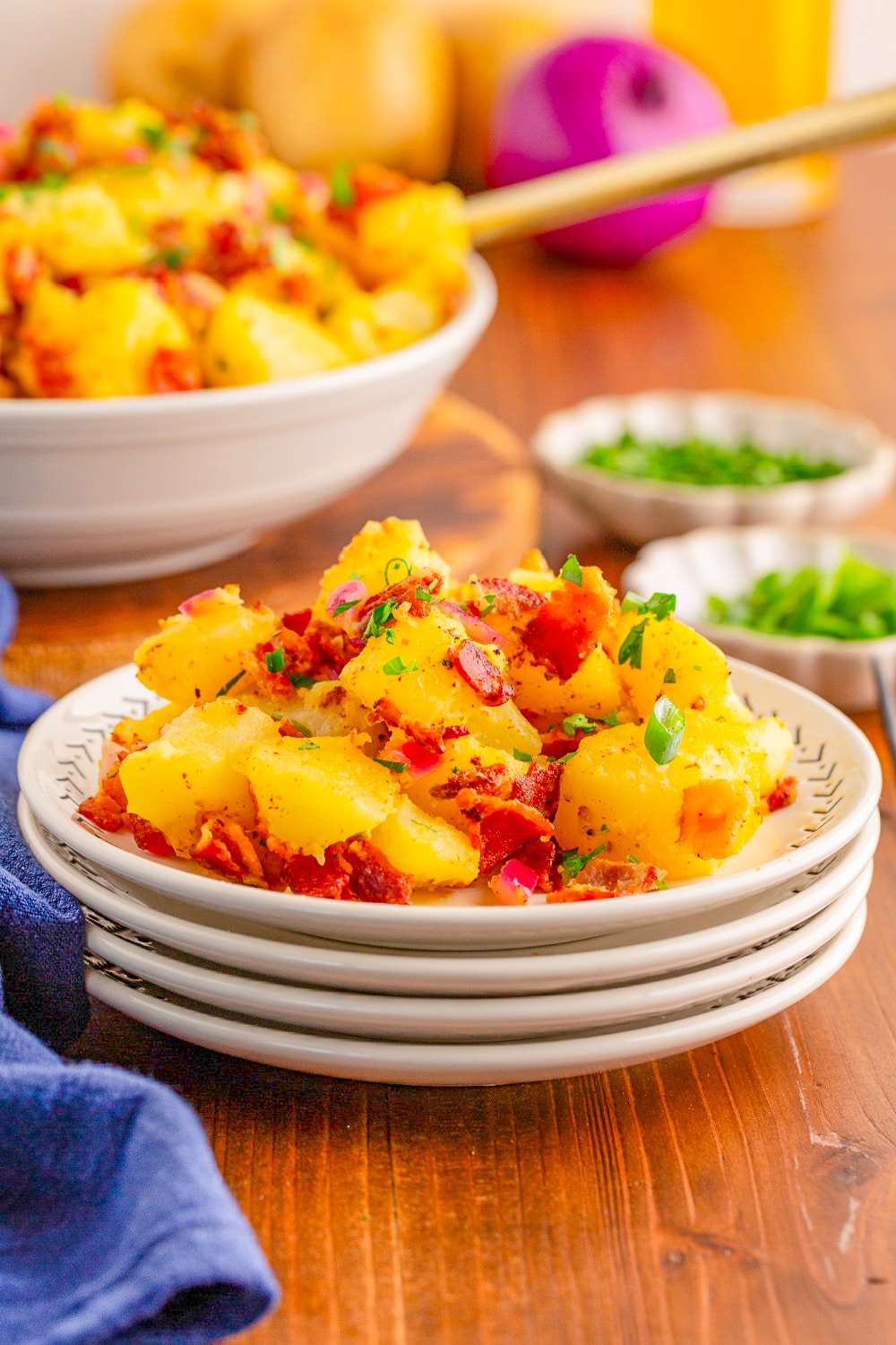 Potato salad with mustard dressing on a small plate.
