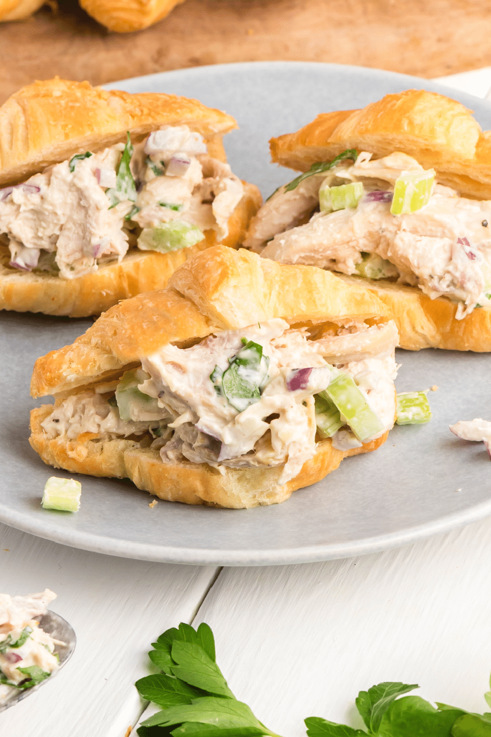 Chicken salad sandwiches on a white plate.