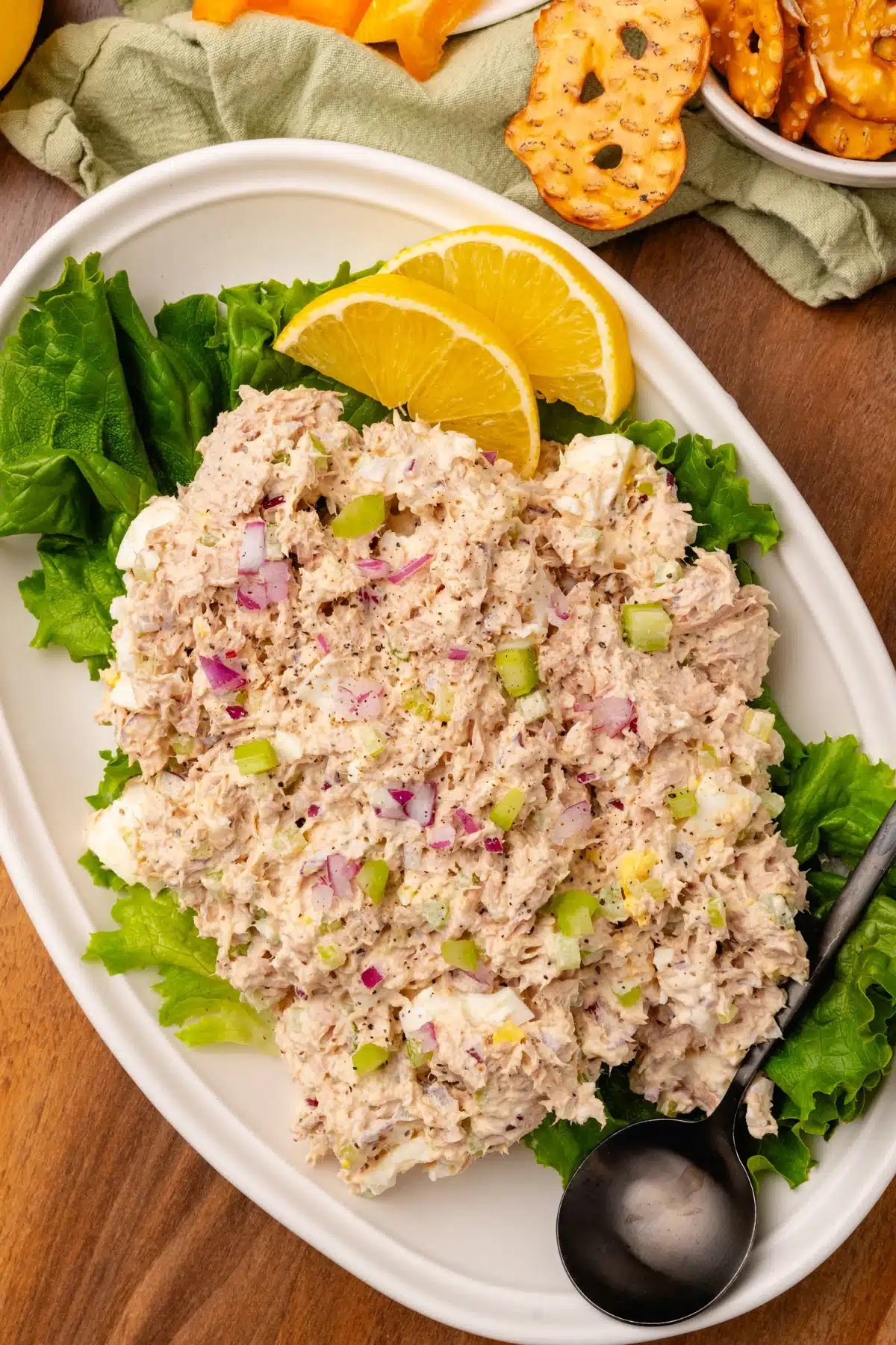 Tuna salad with red onions on a white platter.