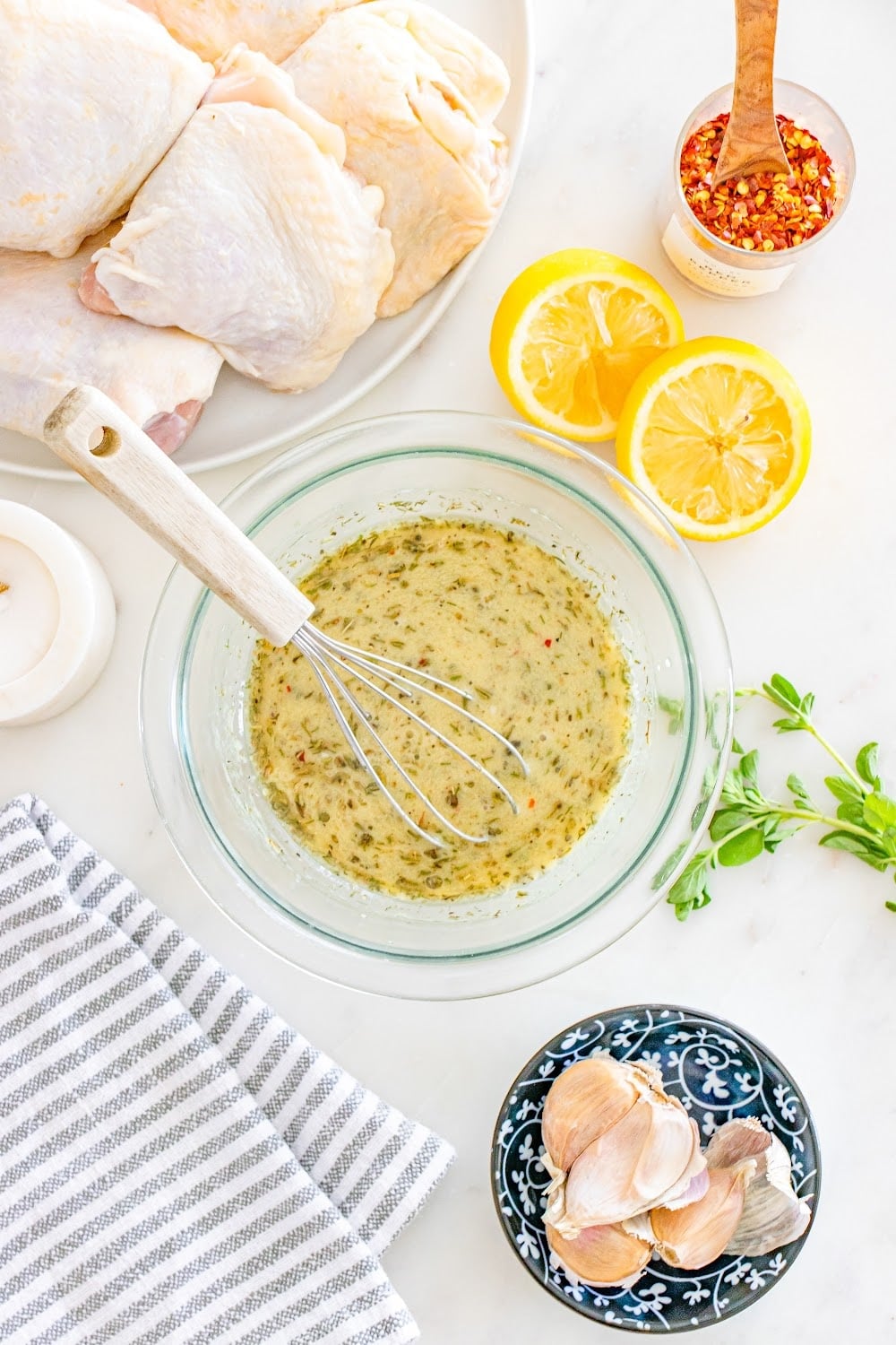 Ingredients whisked together to make marinade in a clear glass bowl.