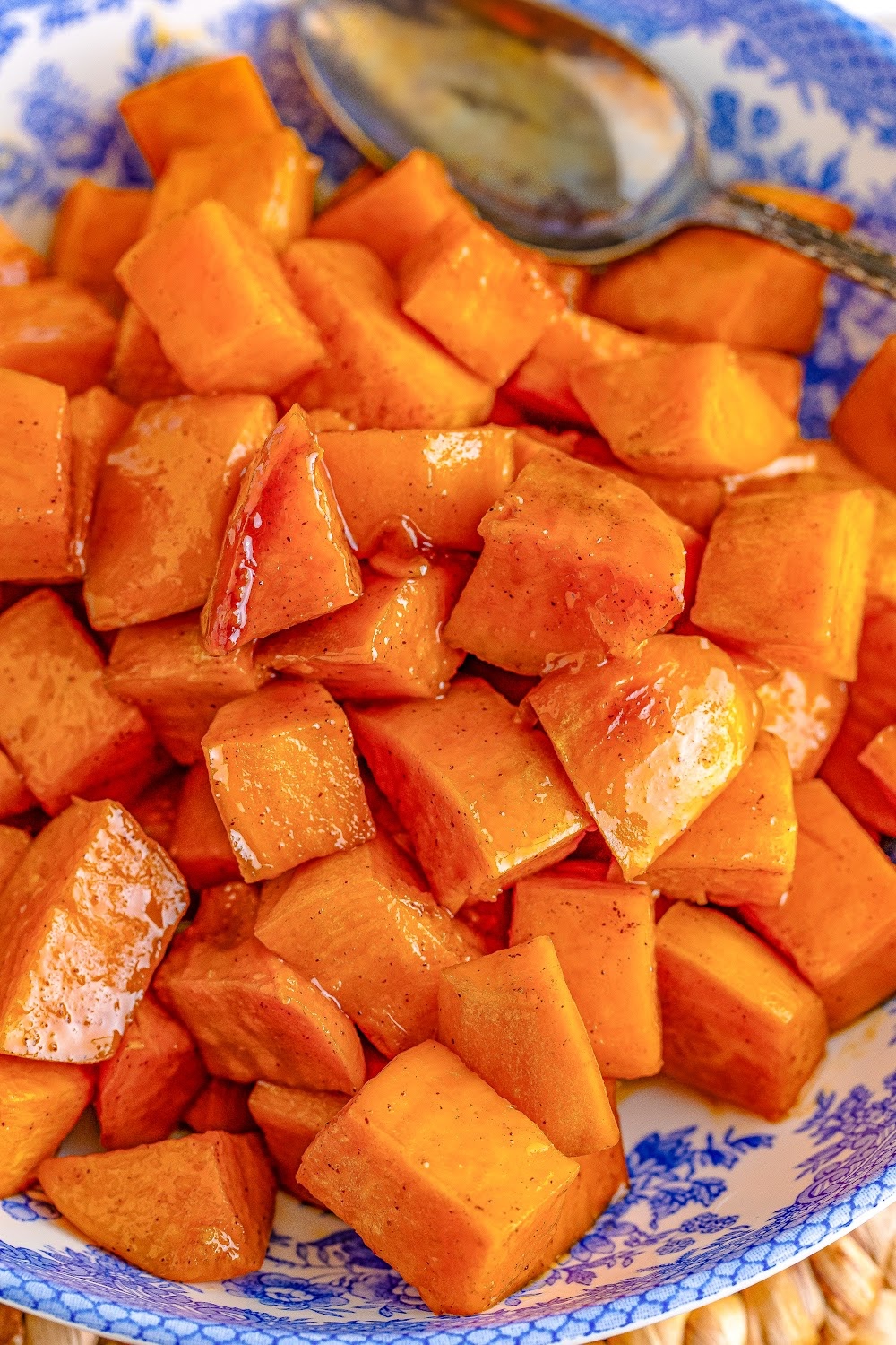 A blue and white bowl filled with sweet potatoes. 