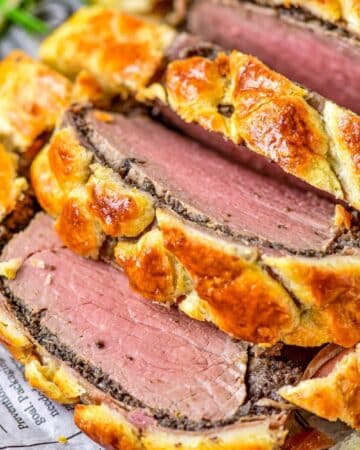 Close up image of the beef sliced inside the puff pastry crust.