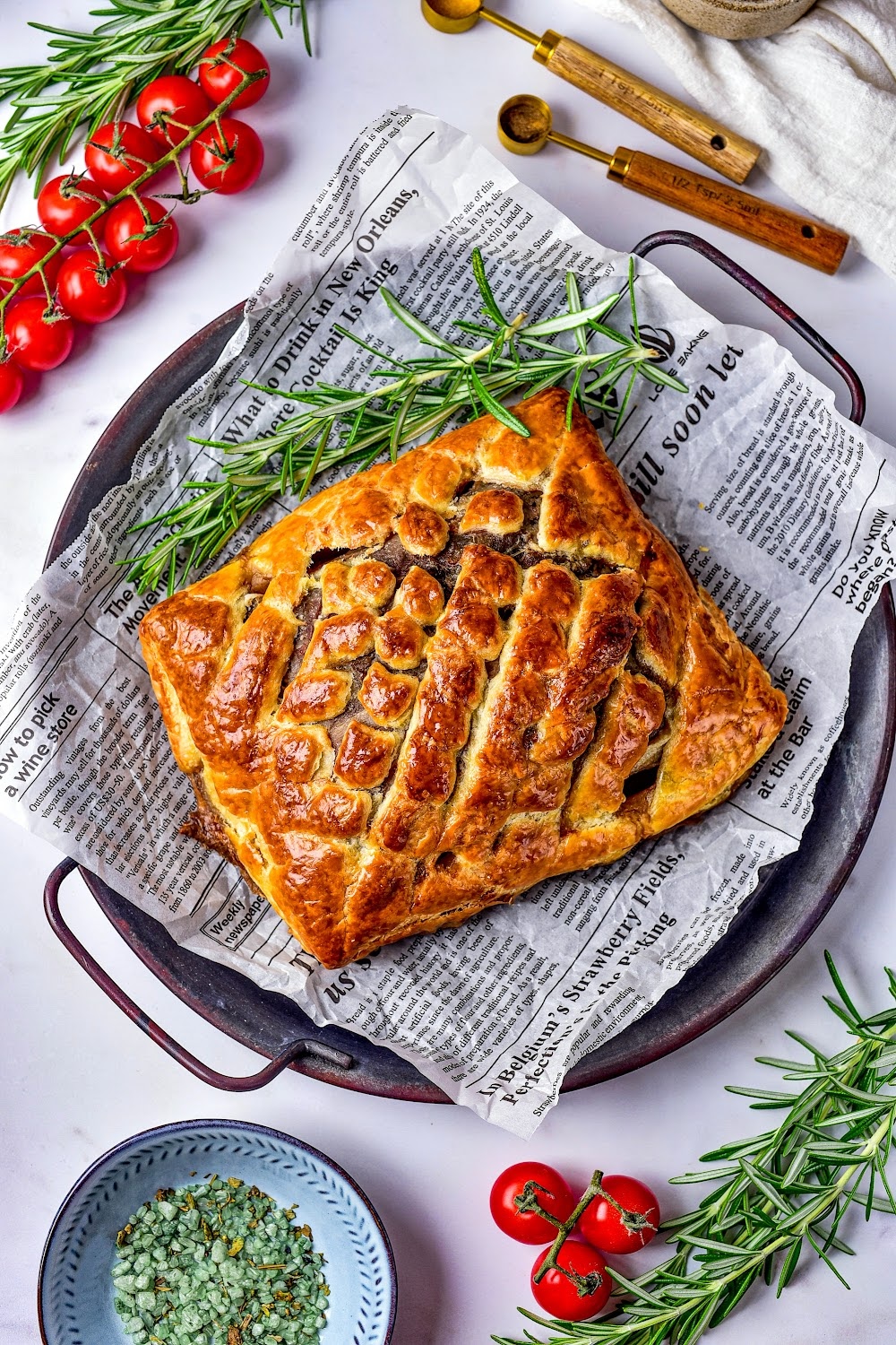 Unsliced Beef Wellington on a serving tray.