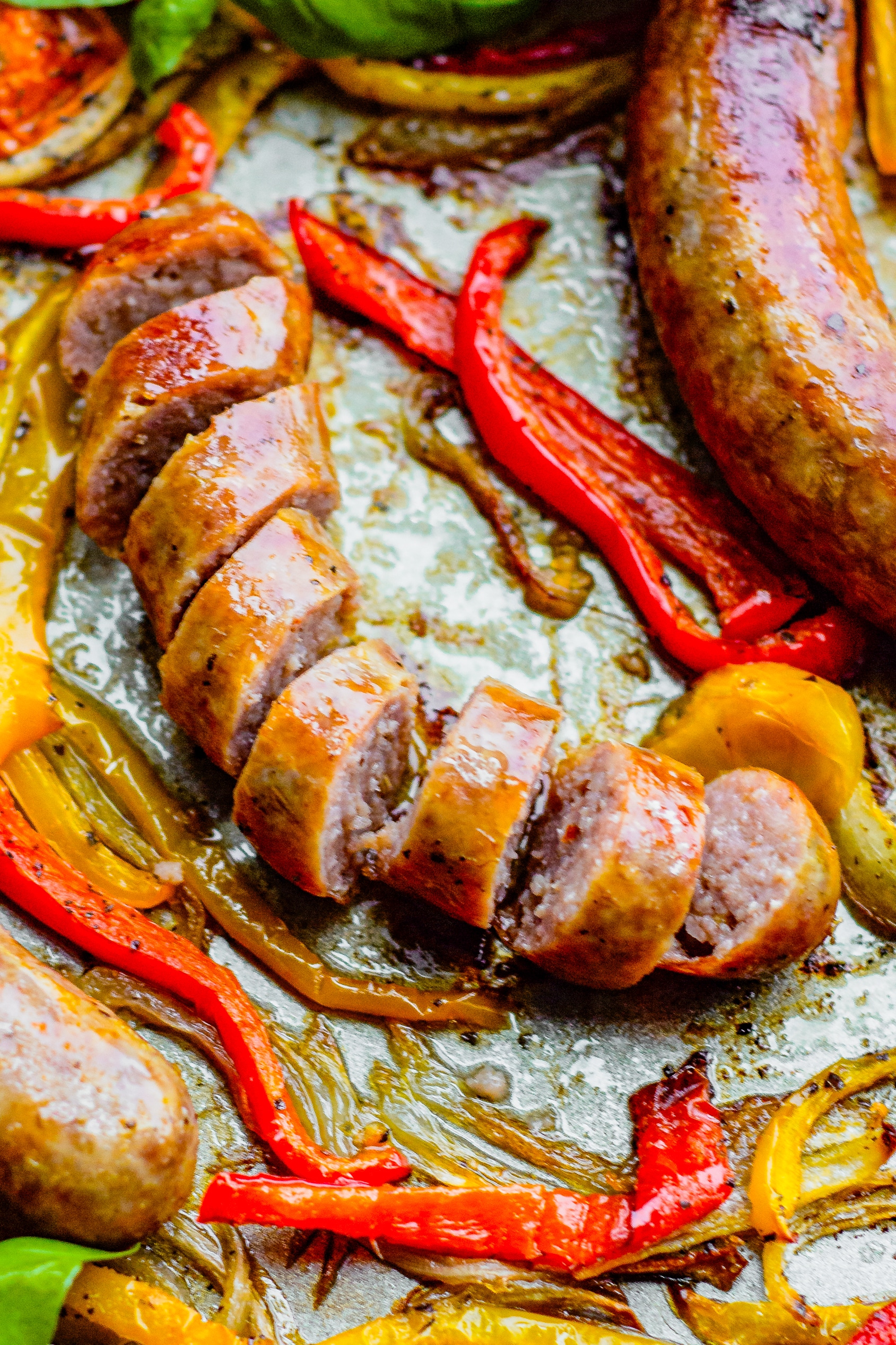 Sliced sausage shower in a bed of onions and bell peppers. 