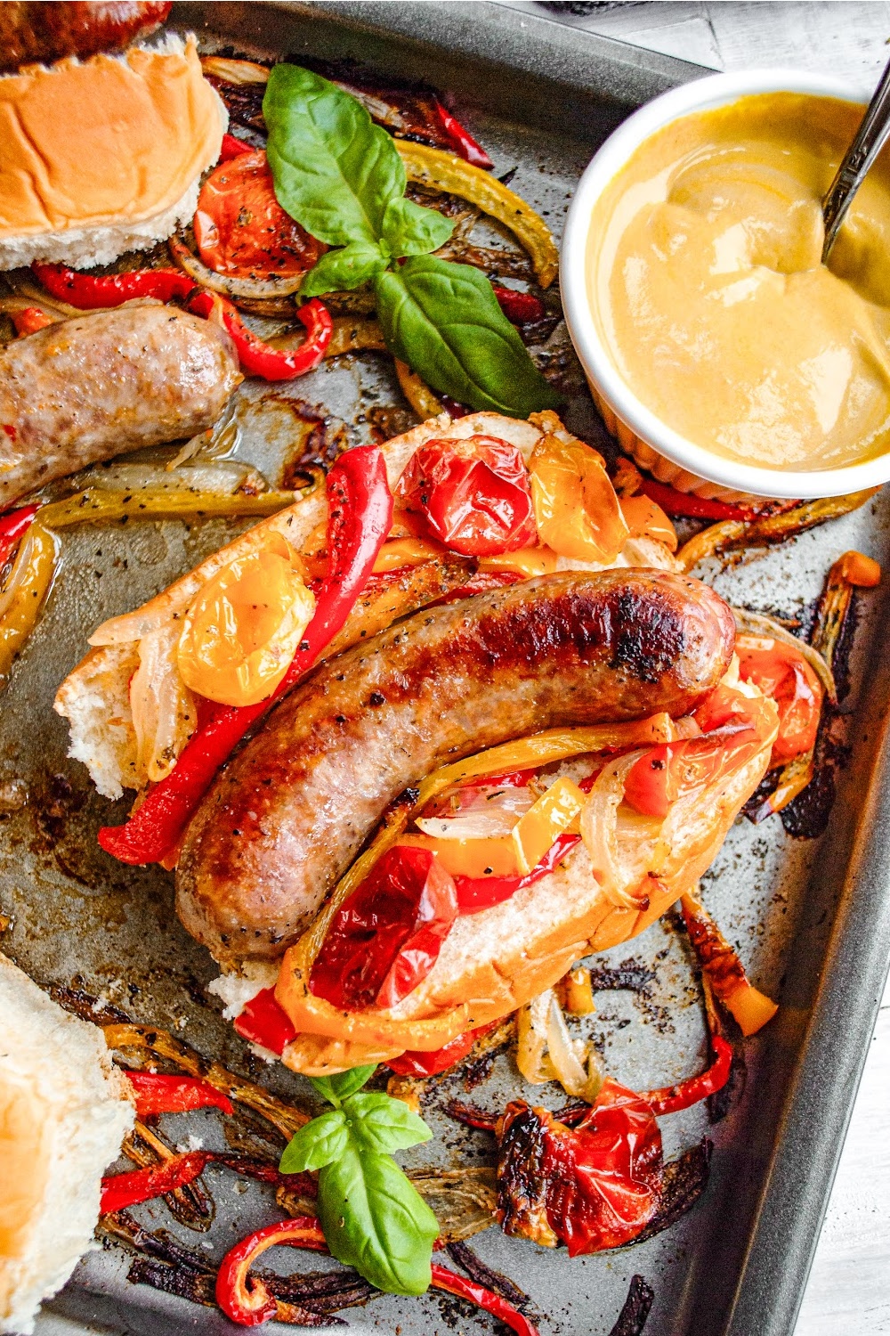 Sausage with peppers and onions on a hoagie roll. 