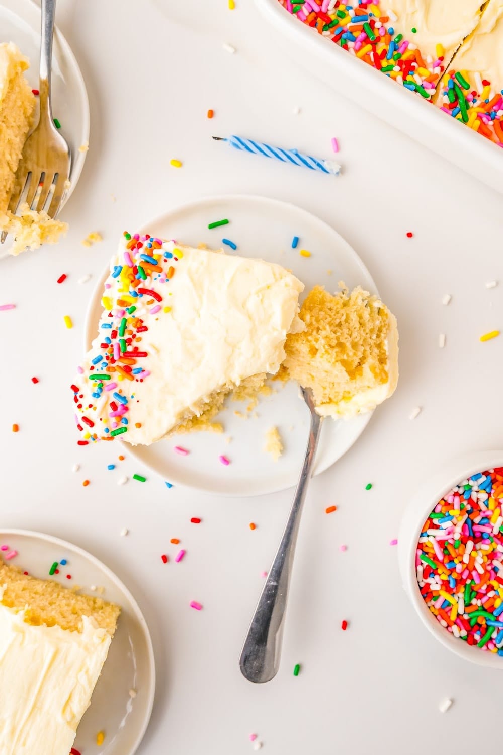 Slices of vanilla cake on a tabletop decorated for a birthday party.